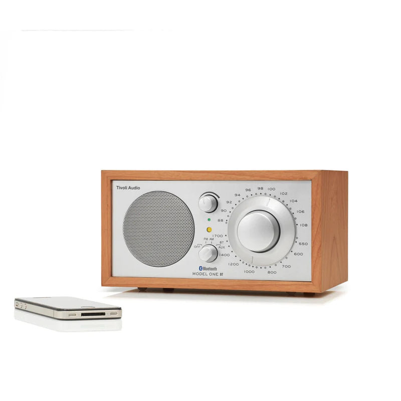 The iconic Model One BT radio delivers timeless style and exceptional sound, with Bluetooth connectivity. Cherry image with phone