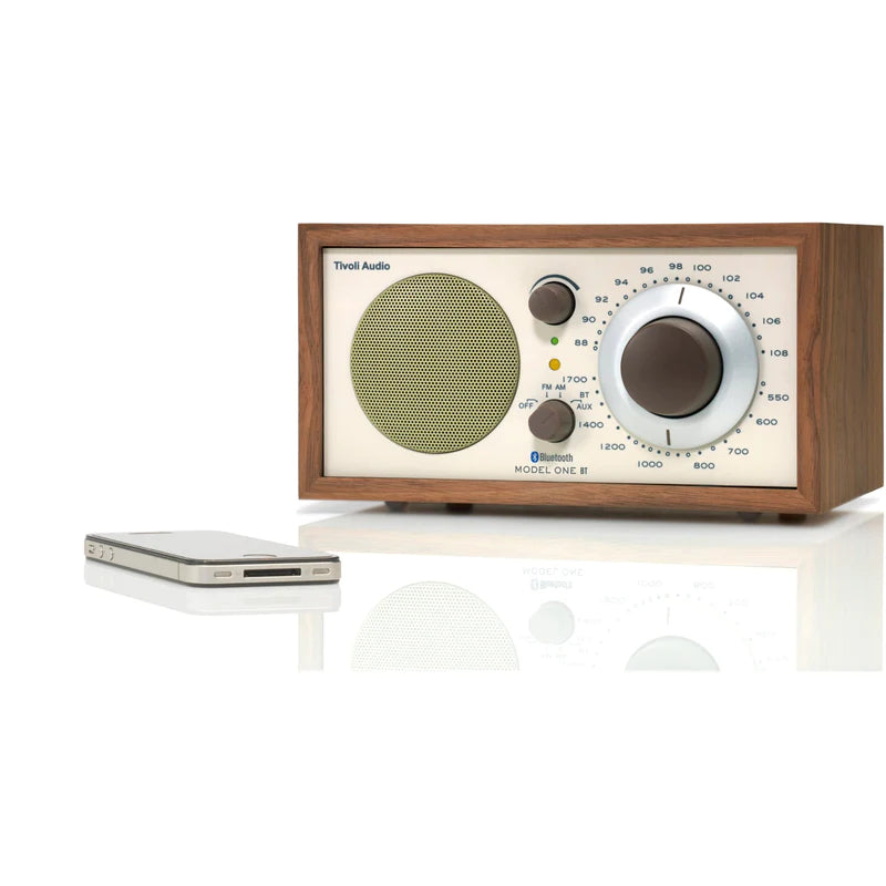 The iconic Model One BT radio delivers timeless style and exceptional sound, with Bluetooth connectivity. Walnut/Beige image with phone