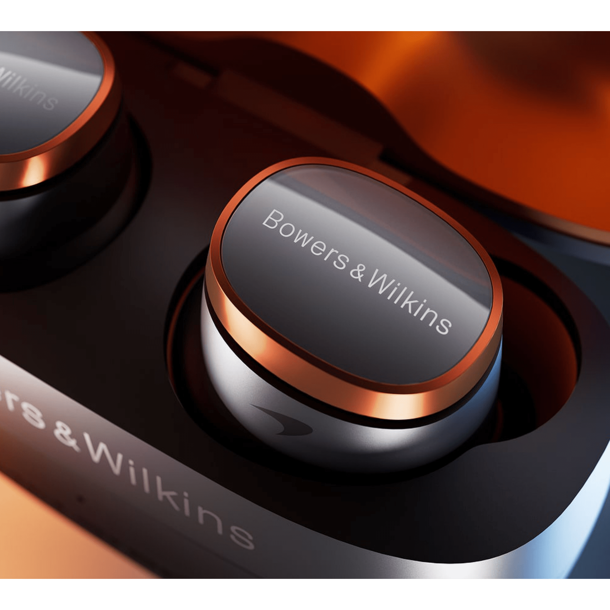 B&W Pi8 Wireless Earbuds McLaren Edition, close up in their case