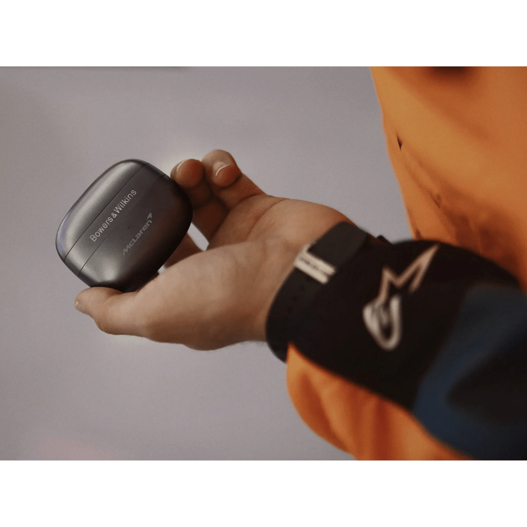 B&W Pi8 Wireless Earbuds McLaren Edition, case in hand