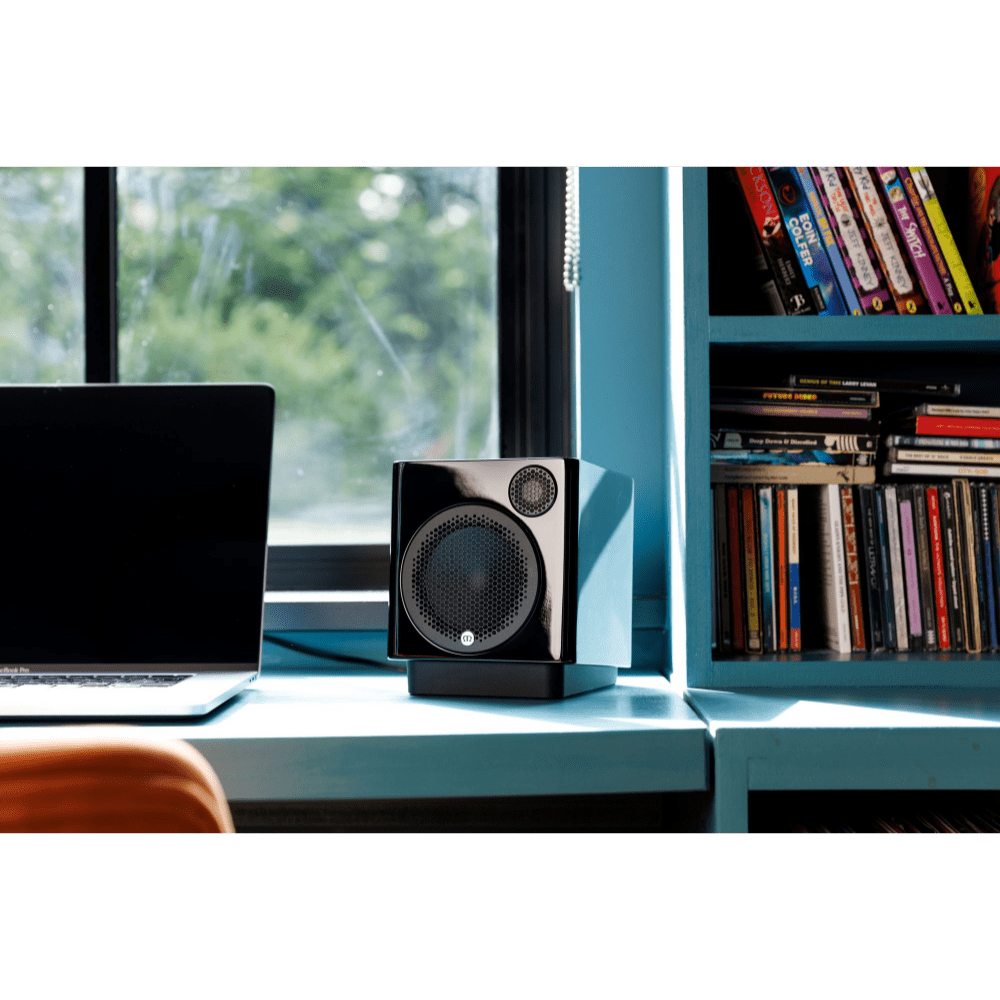 Monitor Audio Radius Desk Pad 4G Isolation Platform shown with Monitor Audio Radius 1 4G Speaker in Gloss Black on desk